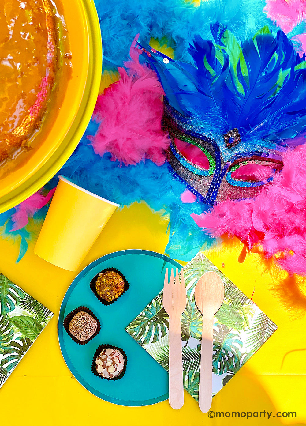 Get ready to throw the ultimate summer celebration with a vibrant Brazilian Carnival-themed party table! Featuring tropical party supplies from Momo Party, this festive setup includes palm leaf napkins, matching plates, and colorful party cups that bring the rainforest vibe to life. Complete the look with feather garlands, carnival masks, decadent chocolate desserts, and a stunning birthday cake. Whether it's for a birthday, summer bash, or themed event, this tropical party setup is perfect for summer!