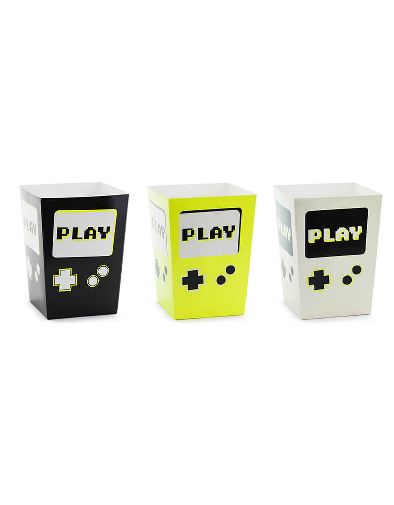 Momo Party's 2.75 x 2.75 x 4.75 inches video game snack boxes by Party Deco. These Game Boy shaped snack boxes in three different colors of black, neon yellow and gray are great for holding party snacks like chips, popcorn, candies and more. They're perfect for kid's video game themed parties.