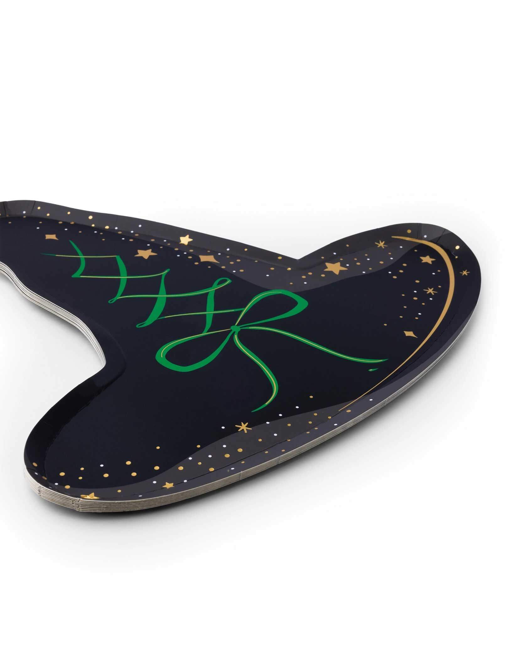 Momo Party's 12.5" x 11.5" black witch hat shaped plate by Bonjour Fete. Comes in a set of 8, crafted with a striking black and emerald green color contrast, these plates add a dramatic flair to your table setting, making it both festive and unique. Perfect for serving treats or snacks, these plates bring charm and fun to your event, ensuring your Halloween soirée or Wicked themed party is truly spellbinding and memorable.