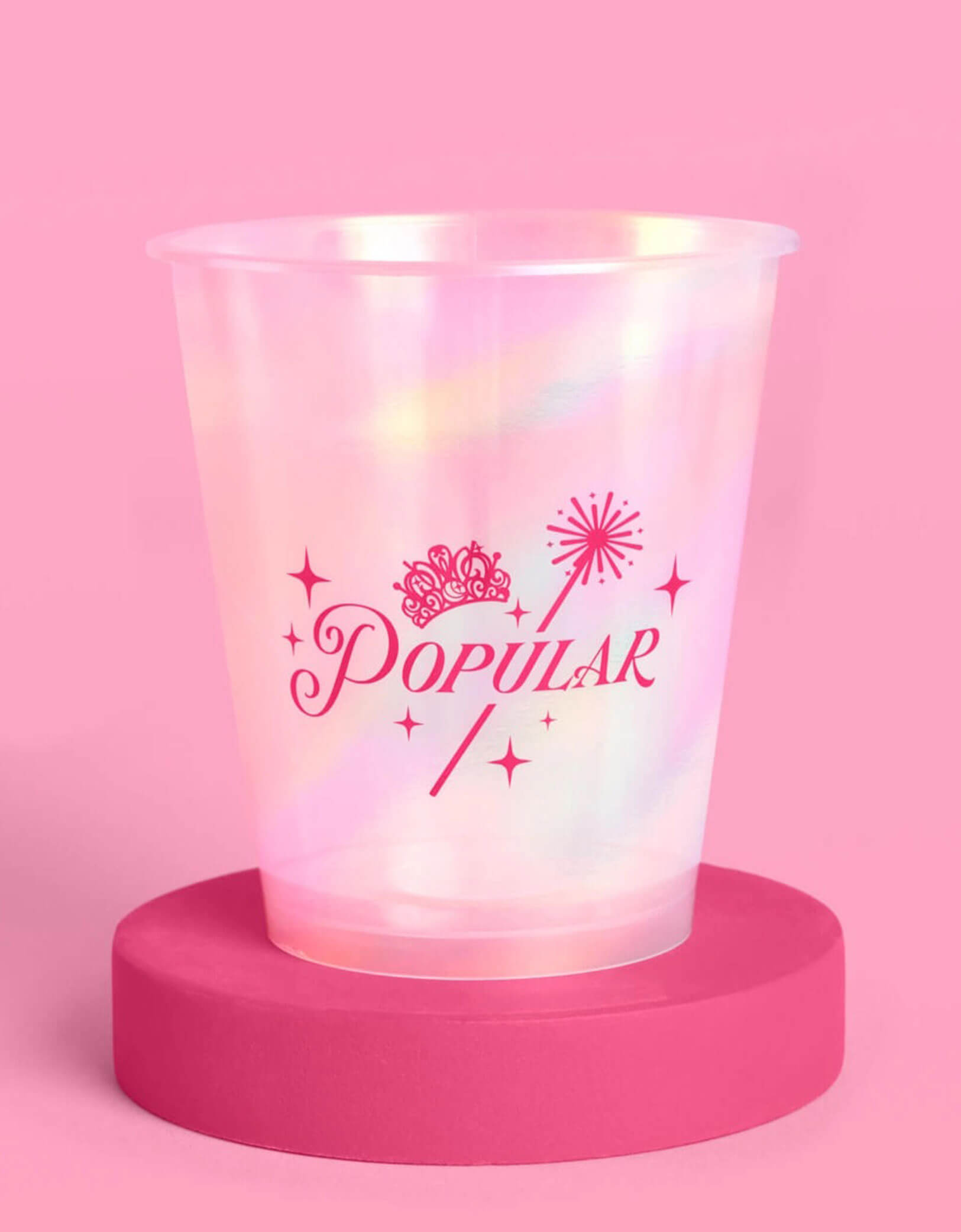 Momo Party's 12oz Wicked pink iridescent plastic cup with 'Popular' design on a pink background.