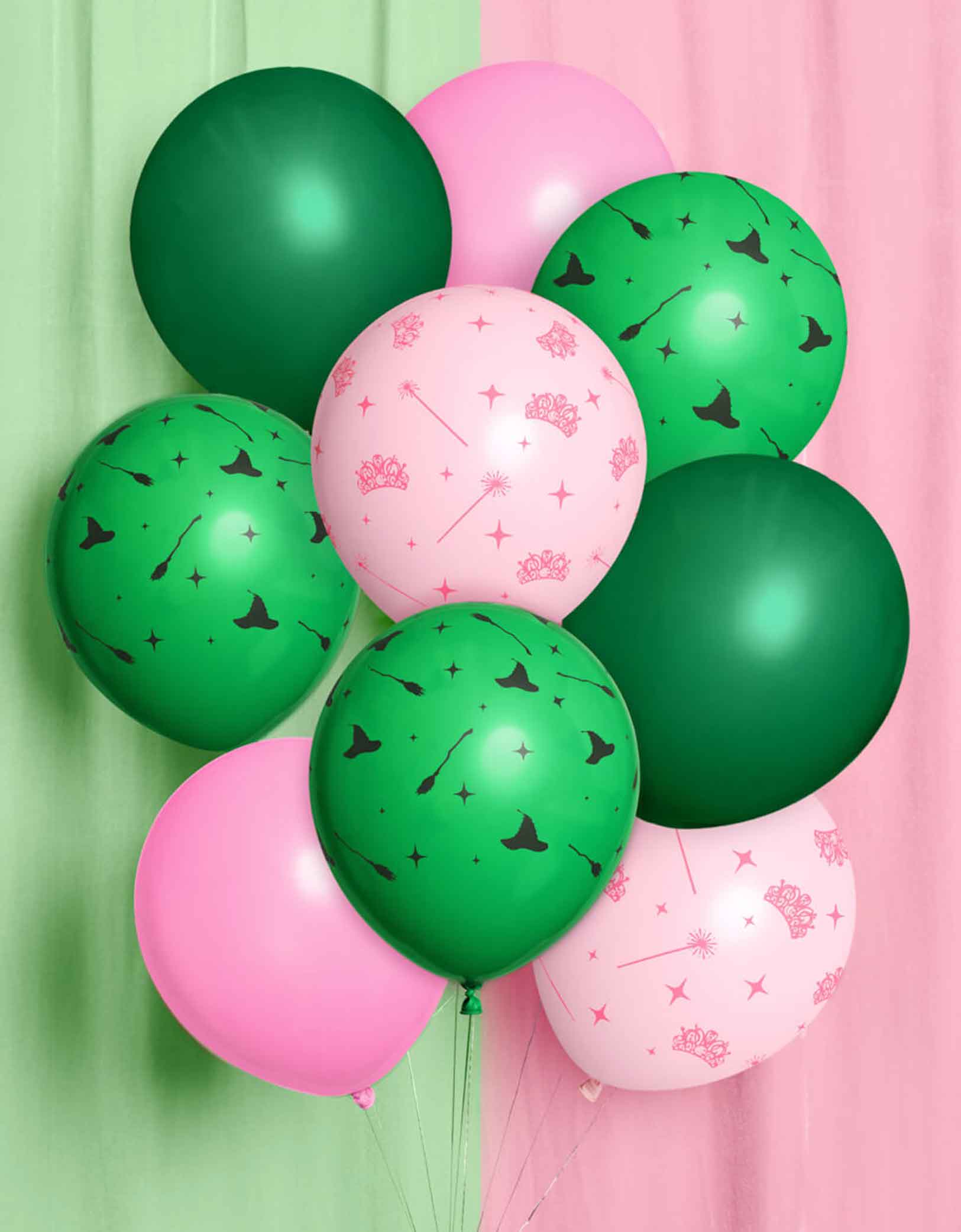 Momo Party's Wicked Witch Emerald City Balloon Mix featuring green and pink latex balloons with Wicked themed element patterns including tiaras, witch hats, witch brooms against a green and pink curtain background.