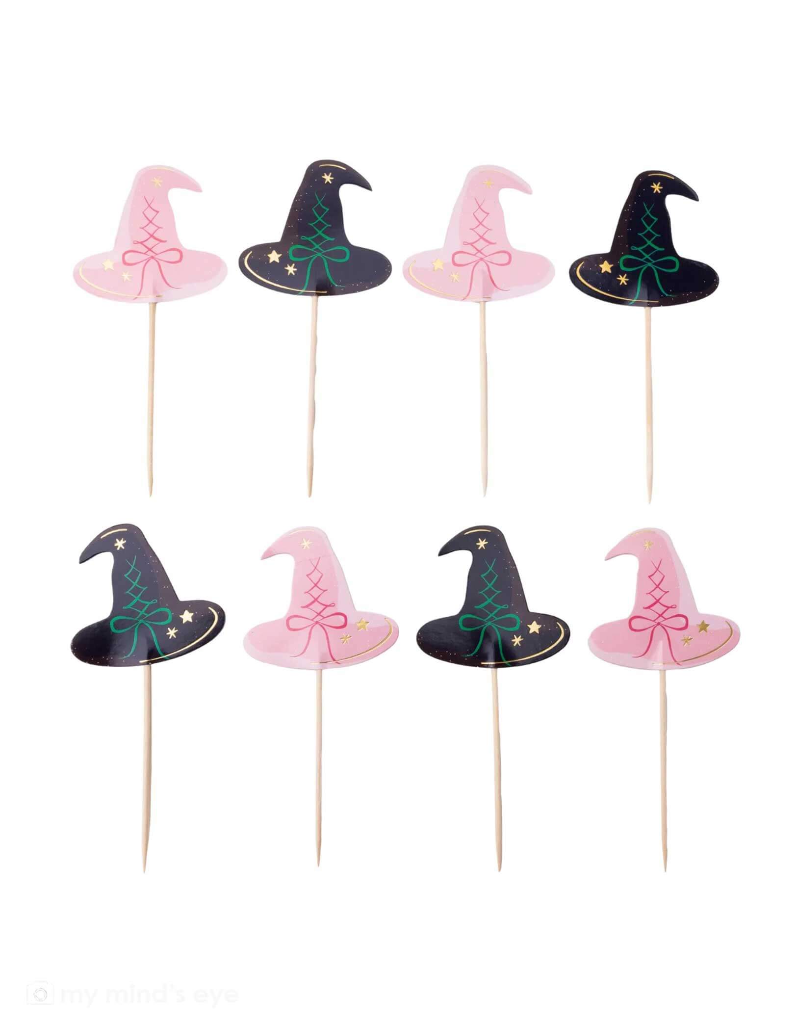 A set of witch hat cake toppers on sticks with pink and black designs from Momo Party, on a white background. These toppers are perfect for a Wicked themed party.