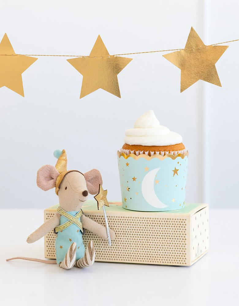 My Minds Eye Baby blue 5 oz Food Cup with a cupcake next to a stuffed mouse toy decoration with gold star party banner on the wall for a baby boy shower
