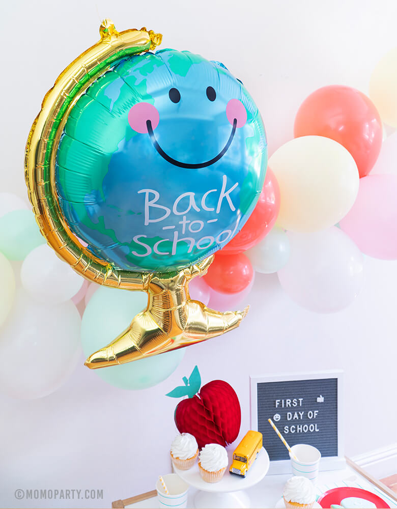 Momo party - Morden Back To School Party inspiration with Anagram Back To School Globe Foil Mylar Balloon, 6ft long Balloon Garland Assorted in Pastel Yellow, Pink, Mint, Carol, White Latex Balloon for Backdrop decoration, Letter board with "First Day of School" sign, Oh happy day Cherry Red side plate, Aqua Striped Large Plates and cups, Leaf Napkins as tableware, Honeycomb Apple, cupcakes, and school bus toy on cake stand