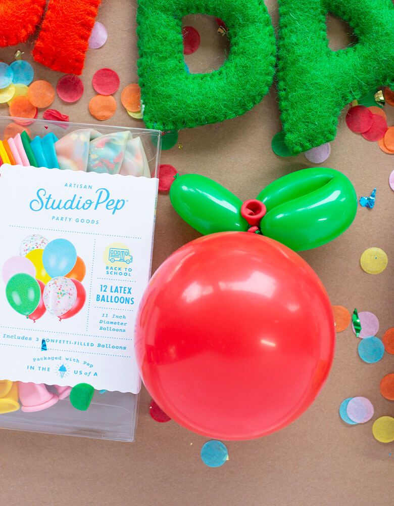 A back to school first day of school party table with Studiopep Apples Balloon and themed confetti