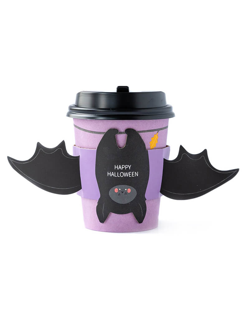 My Mind's Eye BAT HUGS TO-GO COZY CUPS. 8 oz coffee cups with sleeves and lids, this halloween To-Go Cozy Cups featuring a bat with wing sleeve in a purple print cup with "happy halloween" text print on the bat belly, super fun coffee cups for halloween season