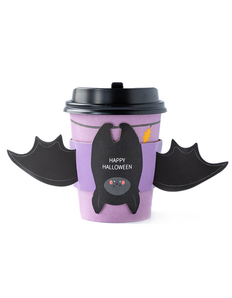 My Mind's Eye BAT HUGS TO-GO COZY CUPS. 8 oz coffee cups with sleeves and lids, this halloween To-Go Cozy Cups featuring a bat with wing sleeve in a purple print cup with "happy halloween" text print on the bat belly, super fun coffee cups for halloween season  