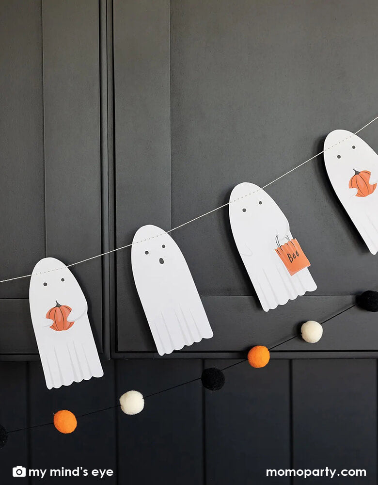 My Mind's Eye Boo Crew Ghost banner. This set includes a die cut banner featuring a spell-binding group of ghosts that will add a spooky effect to any space. And the black, white, and orange pom pom banner will add dimension and a touch of whimsy to make sure that your Halloween party isn't too spooky!