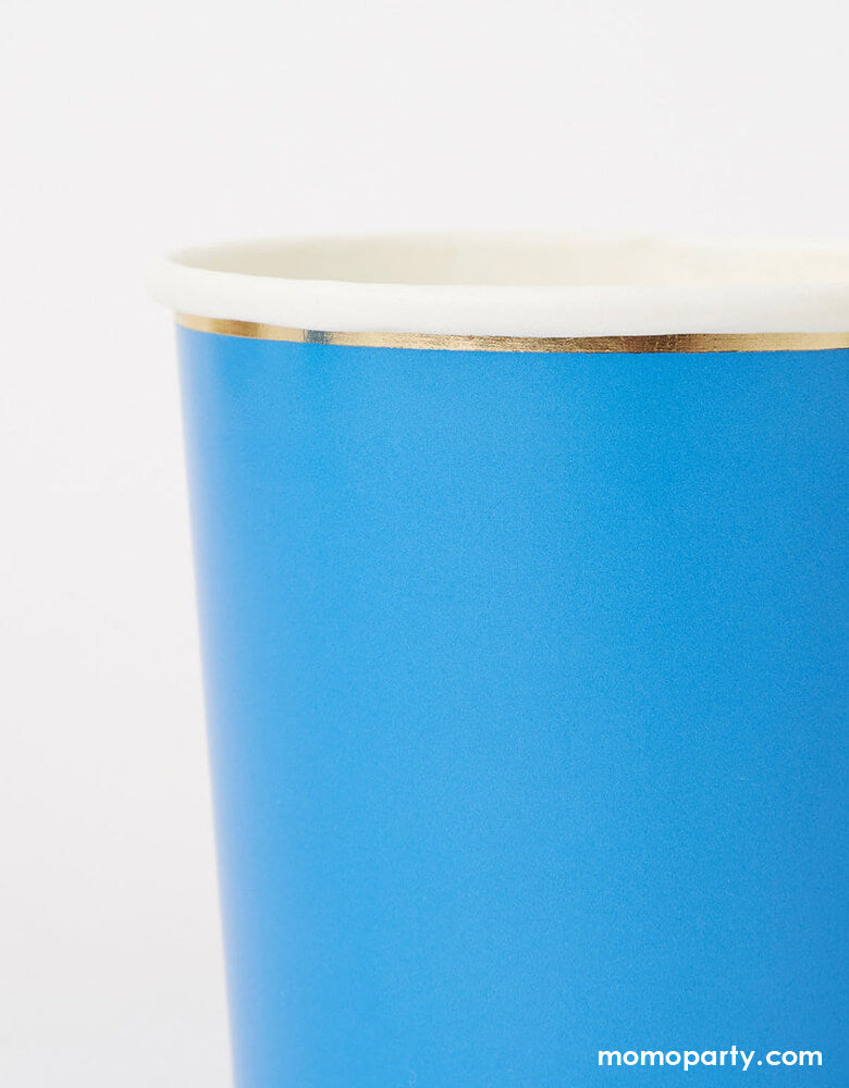 Details of Bright Blue Tumbler Cups by Meri Meri. Made from high-quality card with a superb gloss finish, suitable for hot or cold drinks.These practical yet stylish bright blue tumbler cups, with a shiny gold foil border, are perfect to serve party drinks to glamorous guests