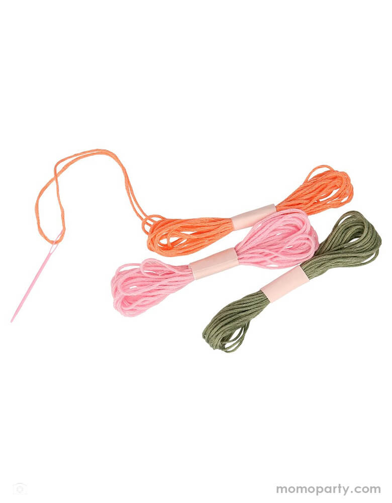 Embroidery threads in pink, peach and green, and a pink plastic wide needle of Meri Meri Bunny Embroidery Kit
