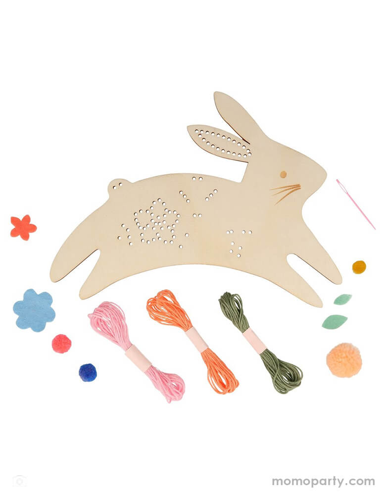 Meri Meri Bunny Embroidery Kit. Including a Leaping Bunny shaped plywood, with holes for the embroidering, Felt flowers and leaves in 4 shades - blue, dark peach, mint and dark yellow.  3 pompoms for a 3-D effect, peach for the tail, and coral and dark blue as flower centers. and Embroidery threads in pink, peach and green for the flowers, leaves and hanging loop. It's a wonderful creative gift that is fun to make, and is then a fabulous decoration to hang up.