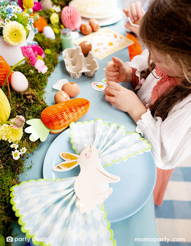 A beautiful Easter table decorated with lots of spring flowers and honeycomb carrot and Easter egg decorations as centerpiece, with Momo Party's 5 x 6.3" bunny napkins by Party Deco, it makes a great inspiration for an adorable kid's Easter tableset.