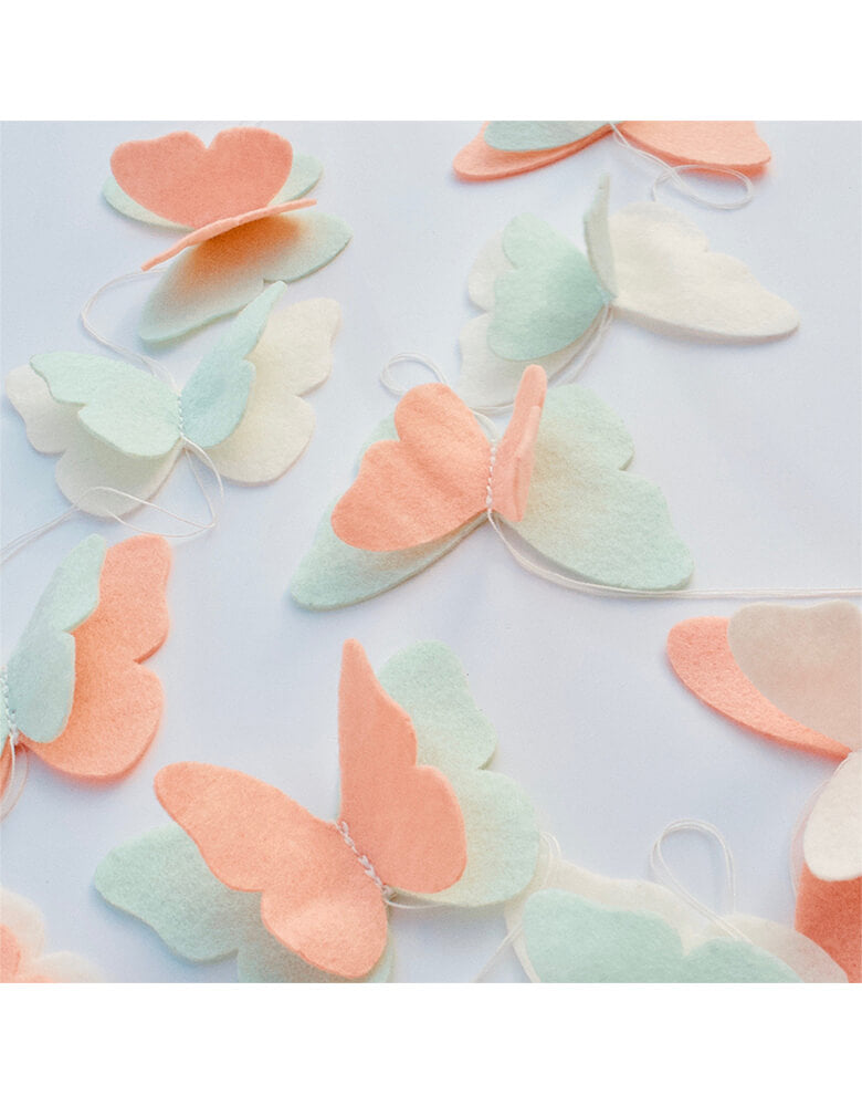 Pooka Party - Butterfly Felt Garland. Featuring a felt garland with peach, mint and white butterflies, this garland is the perfect addition to our Magical Fairies party collection. It's handmade with high quality felt and can be reused in many ways, so the magic can last beyond the celebration day!