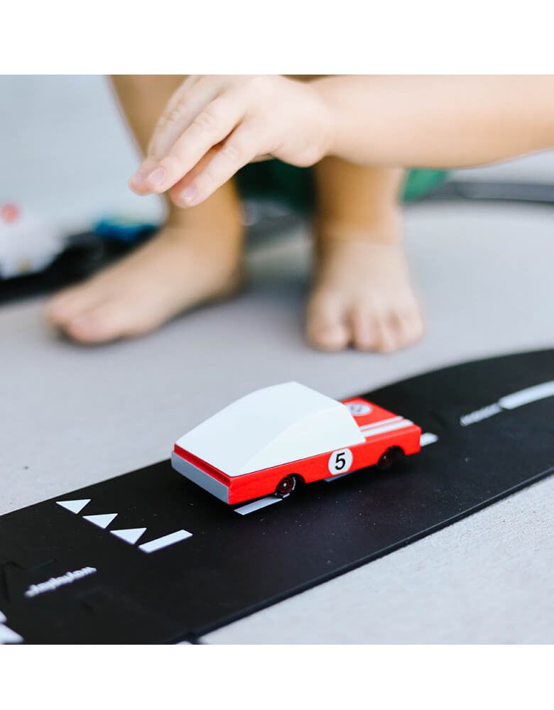 Kids playing Candycar Red Race Car on a toy asphalt road
