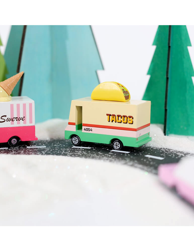 Candylab Candyvan Taco Van on a toy asphalt road with toy trees around 
