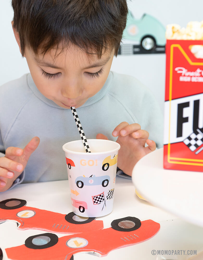 a boy drinking with Meri Meri 9 oz Vintage Race Car Party Cups at a Car themed birthday party