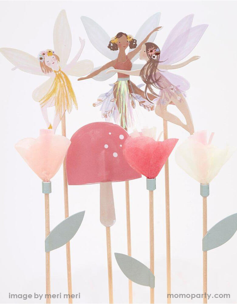 Close up details of Meri Meri Fairy Cake Topper. Featuring 3 fairies, a toadstool and flowers topper
