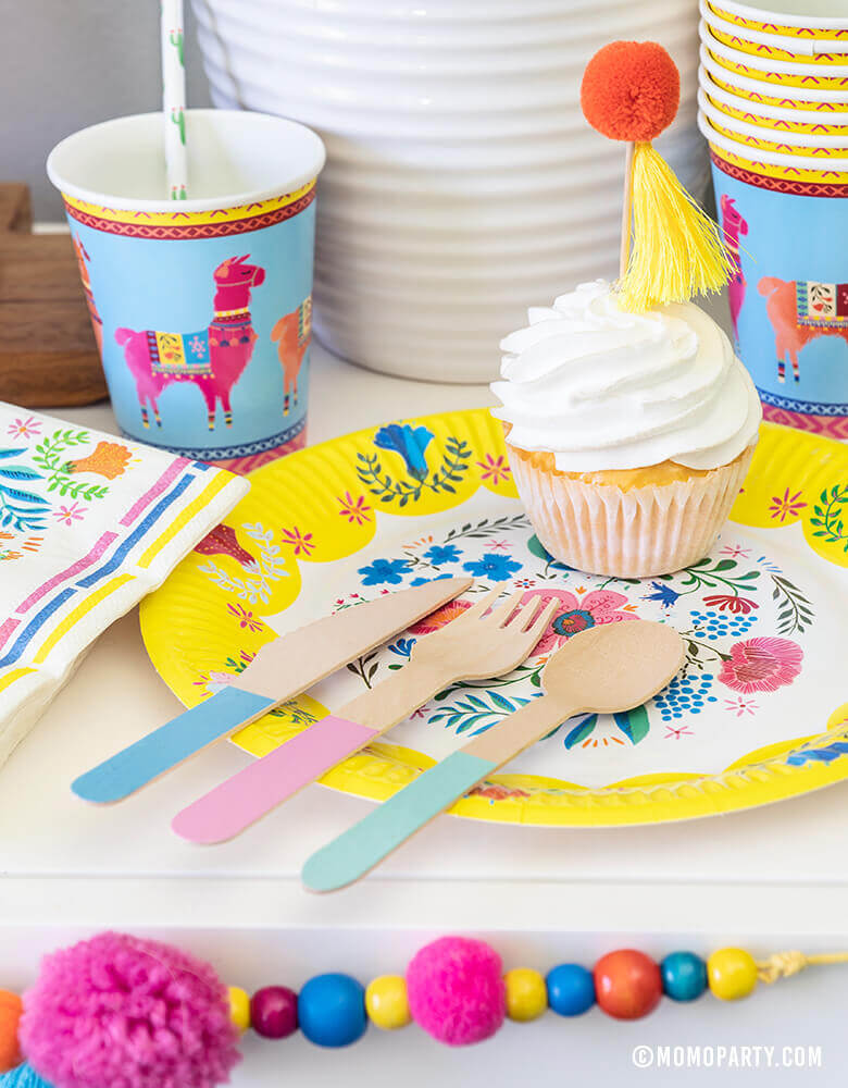 Desert table with Talking Tables 9" Boho Fiesta Floral Plate, Boho Fiesta Llama Cups, Hyper Tropical Wooden Cutlery Set, Boho Fiesta Floral Napkins and Boho Fiesta Pom Pom Garland, for A Boho Fiesta Themed Party, or Modern Cinco De Mayo Party