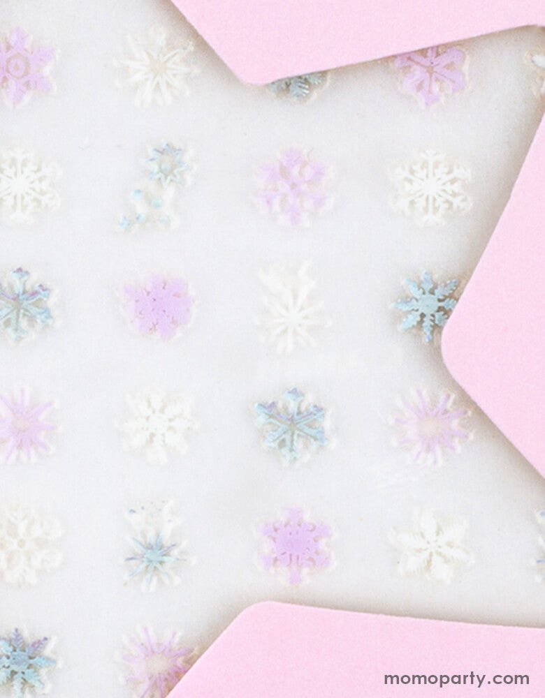 Close up details of Frosted Nail Stickers from Jollity & Co Party Boutique - Daydream society- Frosted collection. Featuring variety colors of snowflakes in morden illustrations with some iridescent details, These frosted nail stickers are perfect for stocking stuffers and goodie bags, activity for a frozen themed birthday party, winter wonderland party, holiday fun activity for mother daughter time. They'll have your hands looking like a winter wonderland faster than a snowflake melts!