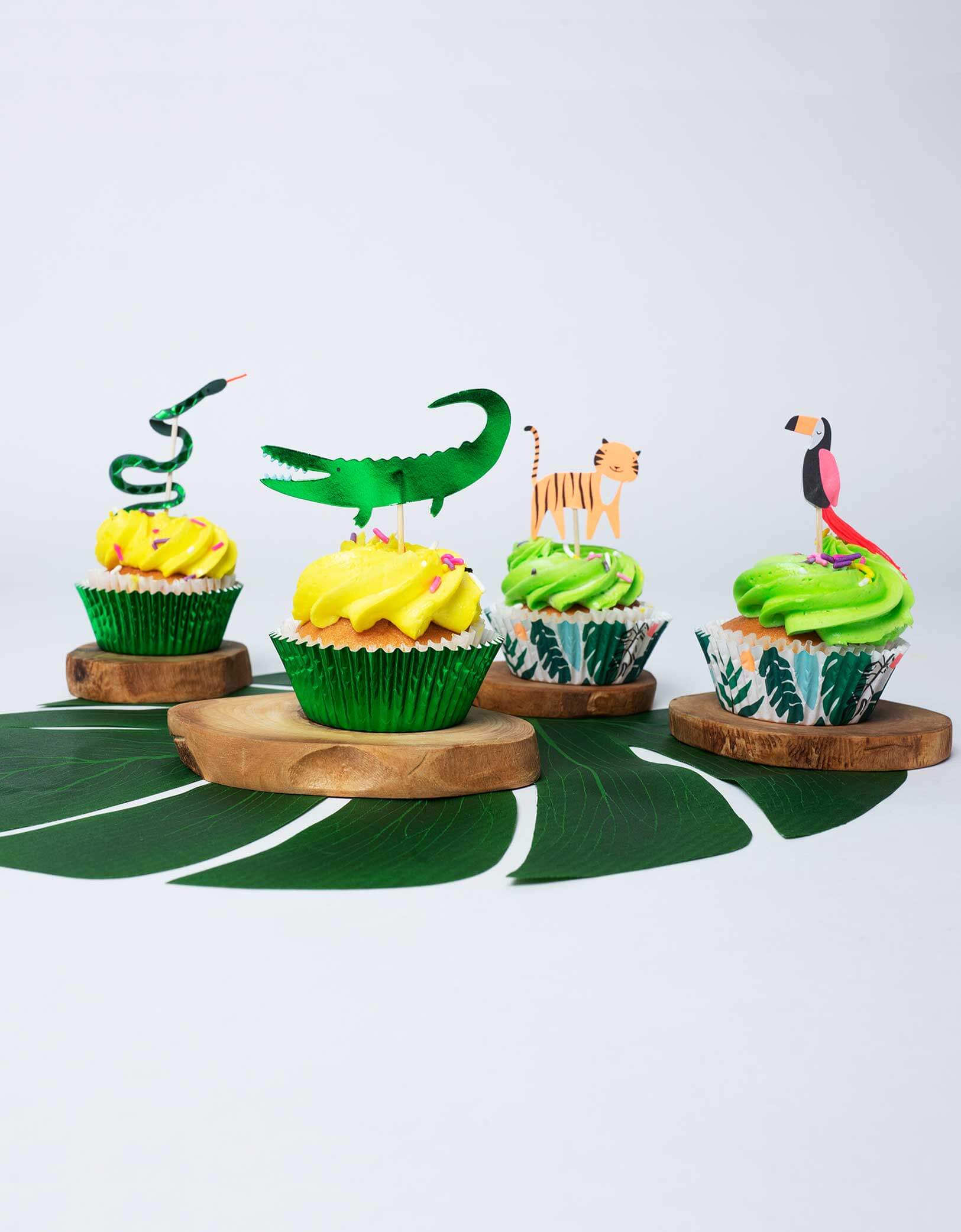 snakes, tigers, crocodiles and toucans toppers on cupcakes