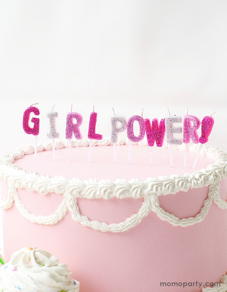a pastel pink butter cake with Party Partners - Girl Power Candle Set.