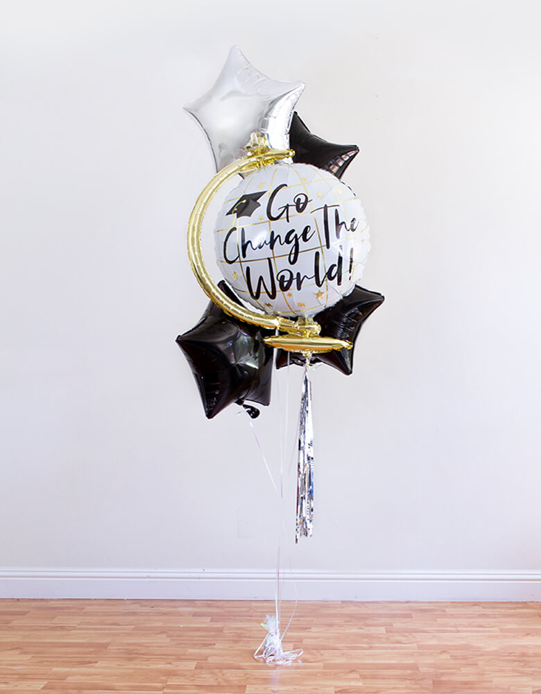 full look of infalted 26" Globe with "Go Change The World" sign Graduation Foil Balloon and silver star, 3 black star Foil Balloons, ribbon, and a balloon weight for a Graduation Party and Celebration at home