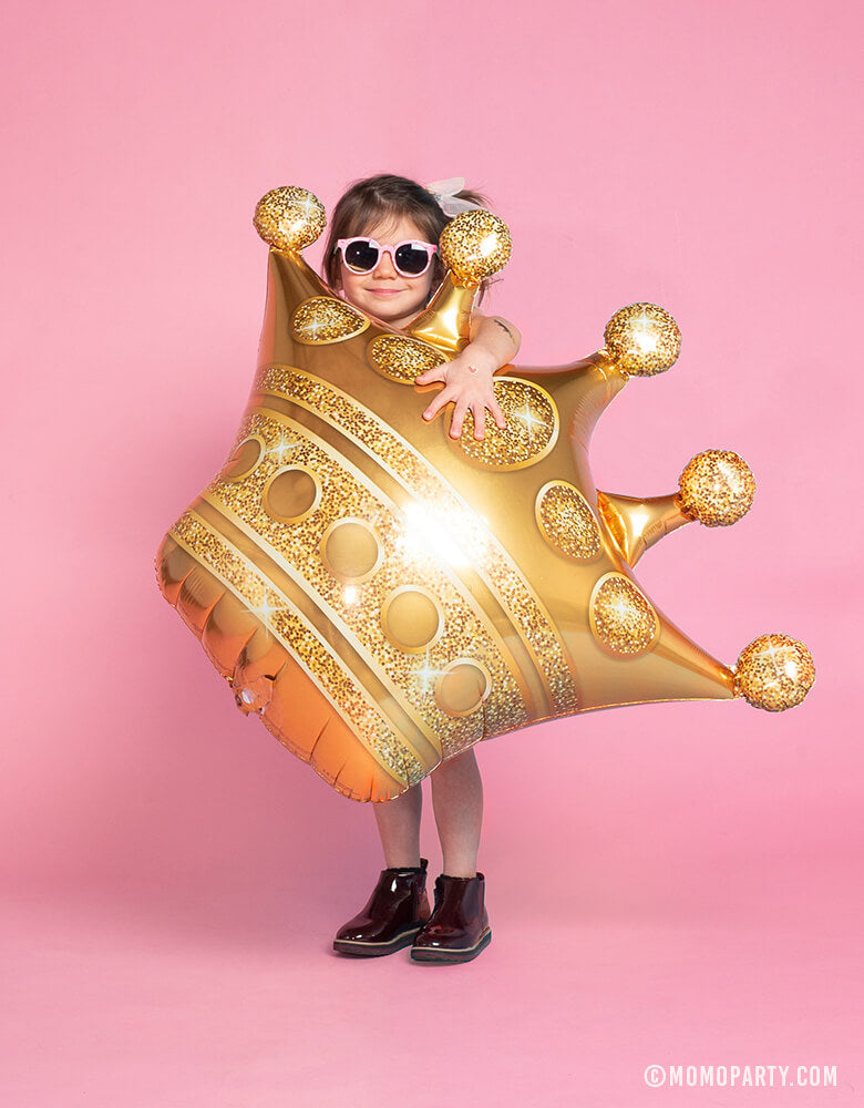Little Girl holding Gold Grown Foil Mylar Balloon with sunglasses