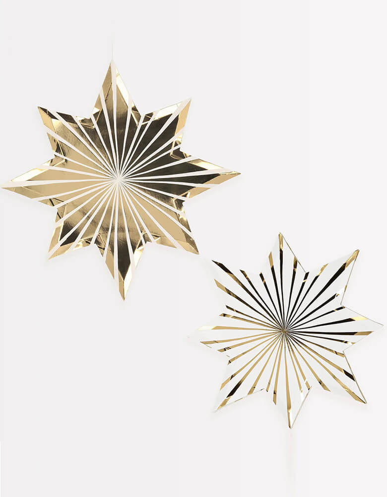 Meri Meri Gold Stripe Star Plates, Sold by Momo Party. Elevate your holiday party table with these fabulous Plates! These paper plates are cleverly crafted with two designs that mirror each other - one is white with gold foil details and in die-cut shape, and the other features gold foil with white details. They are the perfect colors to complement your gold and silver New Year's Eve party, Christmas party, or graduation celebration. 