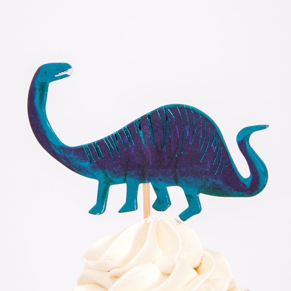 Close up details a cupcake decorated with Blue apatosaurus cupcake topper from Meri Meri Dinosaur Kingdom Cupcake Kit 