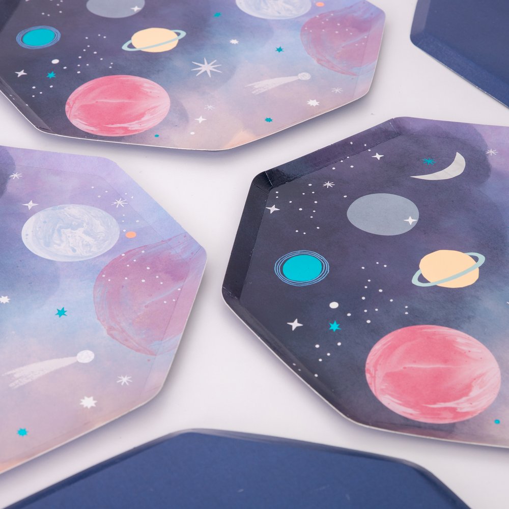 A detail looks of Space Dinner Plates By MeriMeri. Set of 8, Featuring a fabulous planet illustration design with Shiny blue foil and eye-catching silver holographic shiny foil details. With Navy print on the back of the plate. These awesome space plates are crafted from high quality card, so are practical as well as looking out of this world. Perfect for a space themed birthday, blast off birthday, two the moon birthday party or all type of space themed event and celebration.