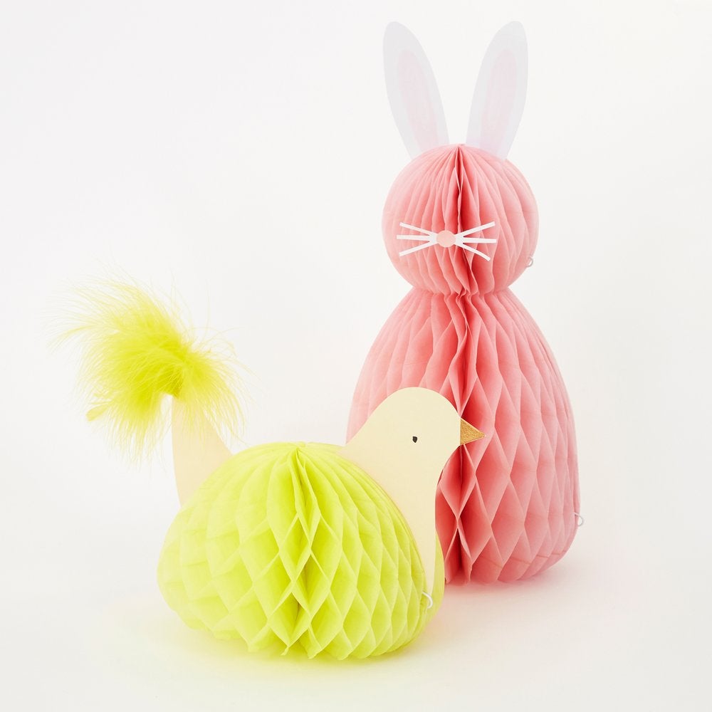 Meri Meri - Easter Honeycomb Decorations. Close up look of A chick adorned with amazing paper tissue honeycomb details and a fluffy tail feathers. A pink honeycomb bunny with pompom tails, paper ears, nose and whisker stickers. This high quality easter decoration is perfect for your easter party table, spring party, farm themed party, easter basket decorations, home decoration for easter.