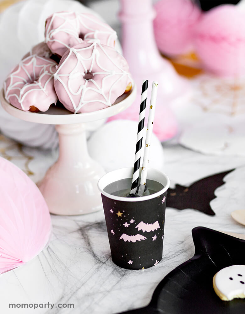 Party Deco Halloween Boo! Paper Cups, with a pastel pink bats and stars in a black cup with Black stripe and Gold star party straws, with a pink spider donuts in a cup stand for a pink Halloween party!