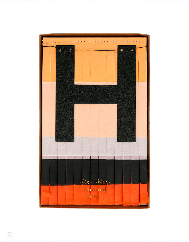 Meri Meri 217414 Halloween Fringe Garland in a clear package. This Garland 4.75' x 9.75' Length garland's pennants are made with 2 layers each of peach, dusty pink, black and orange fringed tissue paper. It is beautifully crafted from fringed tissue paper, with glittered letters spelling out "Happy Halloween". The fringing is stitched together with satin ribbon at either end. The letters are sprinkled with glitter. vintage look halloween garland for your halloween home decoration or a halloween party