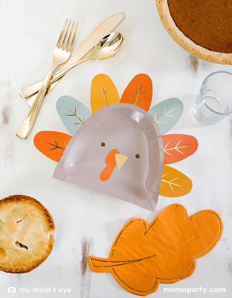 Thanksgiving Table with My mind's Eye - THP844 - HARVEST TURKEY SHAPED 9" PLATE, Thanksgiving Gold Oak Leaf Napkins, pie and golden utensils. These modern designed party supplies are perfect for thanksgiving, holiday celebration. Perfect to try one of every flavor of pie, these plates make for a bright holiday experience. Or keep the kids gathered around the kid's table for seconds with these fun turkey plates