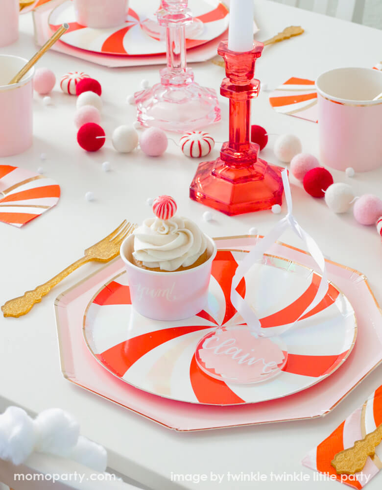 A Christmas Party Tablescape idea with Peppermint Plate Layerd with Dusty Pink Plates, along with candy cane napkins