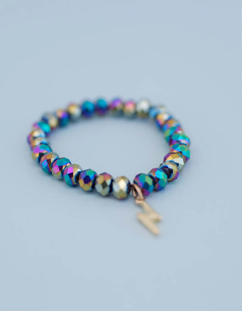 This lightning bolt revolt bracelet holds a dark holographic pattern and a gold lightning bolt charm. It makes a great goodie bag stuffer for a superhero themed party!