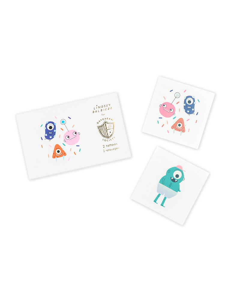 Jollity & Co Party Boutique - Daydream society collection - Little Monsters Temporary Tattoos. Pack of 2 tattoos (1 each of 2 designs), Each tattoo measures 2.5 inches square. Packaged in a card stock envelope. These Safe + non-toxic temporary tattoos featuring a bright color palette full of neons and pops of holographic silver foil, these monster tattoos deliver monstrous amounts of fun! They also make great stuffers for the goodie bags!
