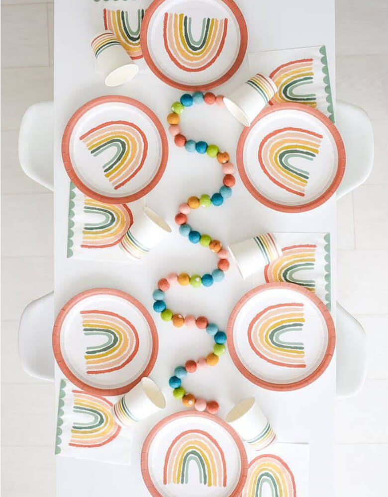 A modern party table flat lay shot filled with Lucy Darling's rainbow themed tabletops