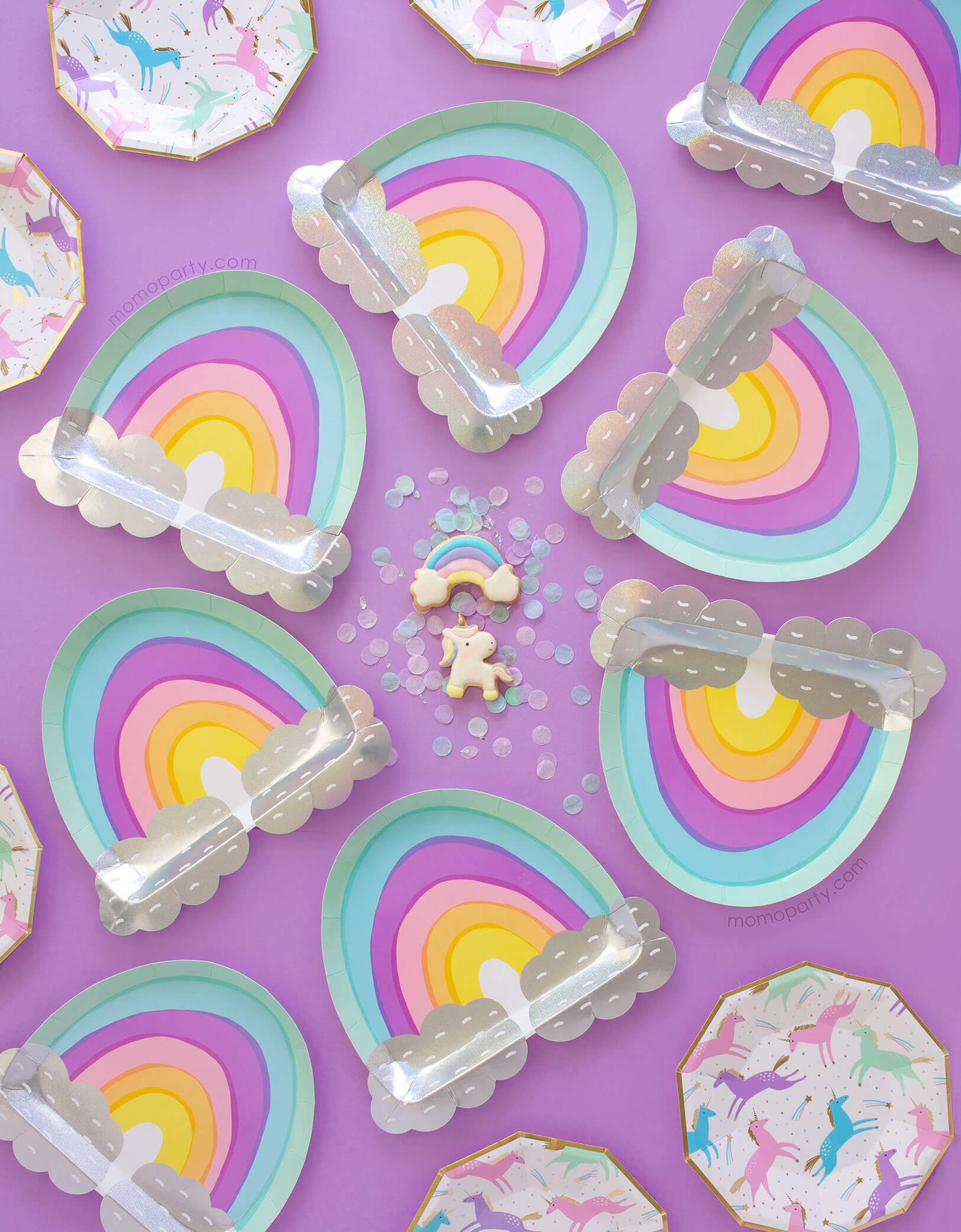  cute unicorn and rainbow cookies around with confetti and rainbow plates