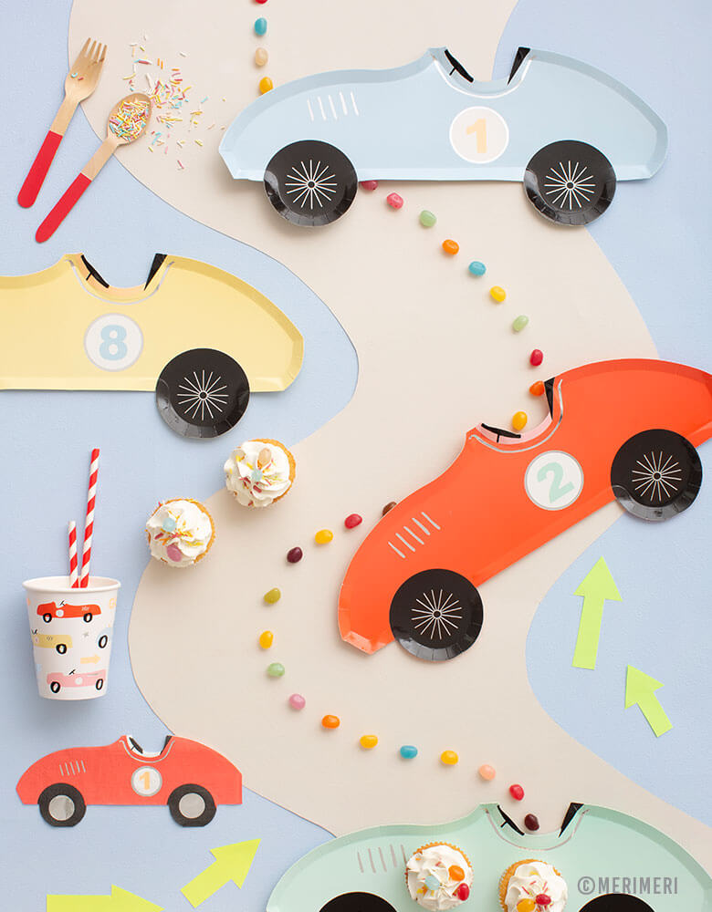 A car themed party table with Meri Meri's Vintage Race Car Tableware Collection including car shaped plates, napkins and car illustrated cups