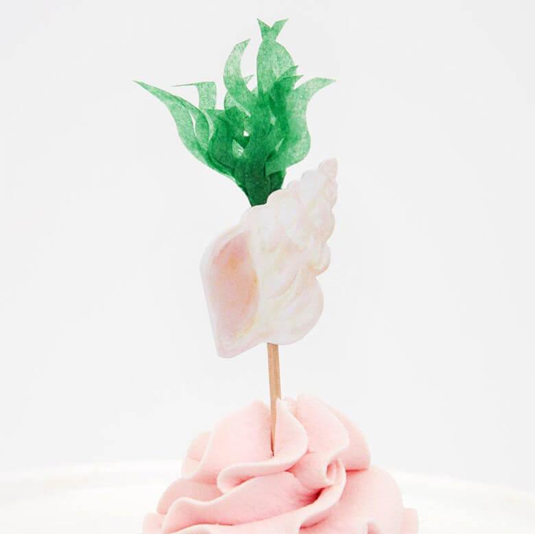Meri Meri Mermaid Cupcake Kit topper with a watercolor illustrated pastel pink conch and tissue paper made seaweed design