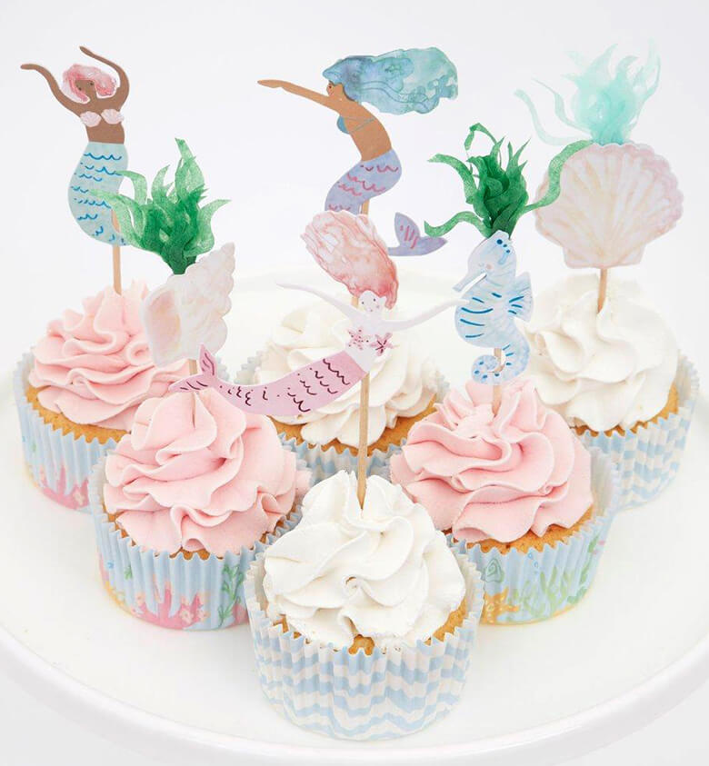 Pink and white cupcakes decorated with Meri Meri mermaid cupcake kit. With beautiful mermaids, a seahorse and seaweed toppers and pastel blue color cupcake cases.