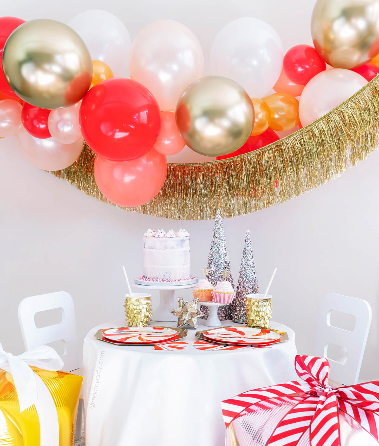 Momo Party Holiday party box - Christmas Candy Cane Glam Holiday Box, Featuring Meri Meri Gold Large Dinner Plates, Peppermint Swirl Side Plates, Gold Fringe Party Cups, Candy Cane Napkins, Silver Wooden Cutlery Set, Gold Star Party Straws, Gold Tinsel Fringe Garland, Candy-cane-glam themed Gold, Red, Pearl White, Coral, Pearl peach latex balloon garland. decorated with your cake, cupcakes, sparking trees for a modern classic cute christmas holiday celebration