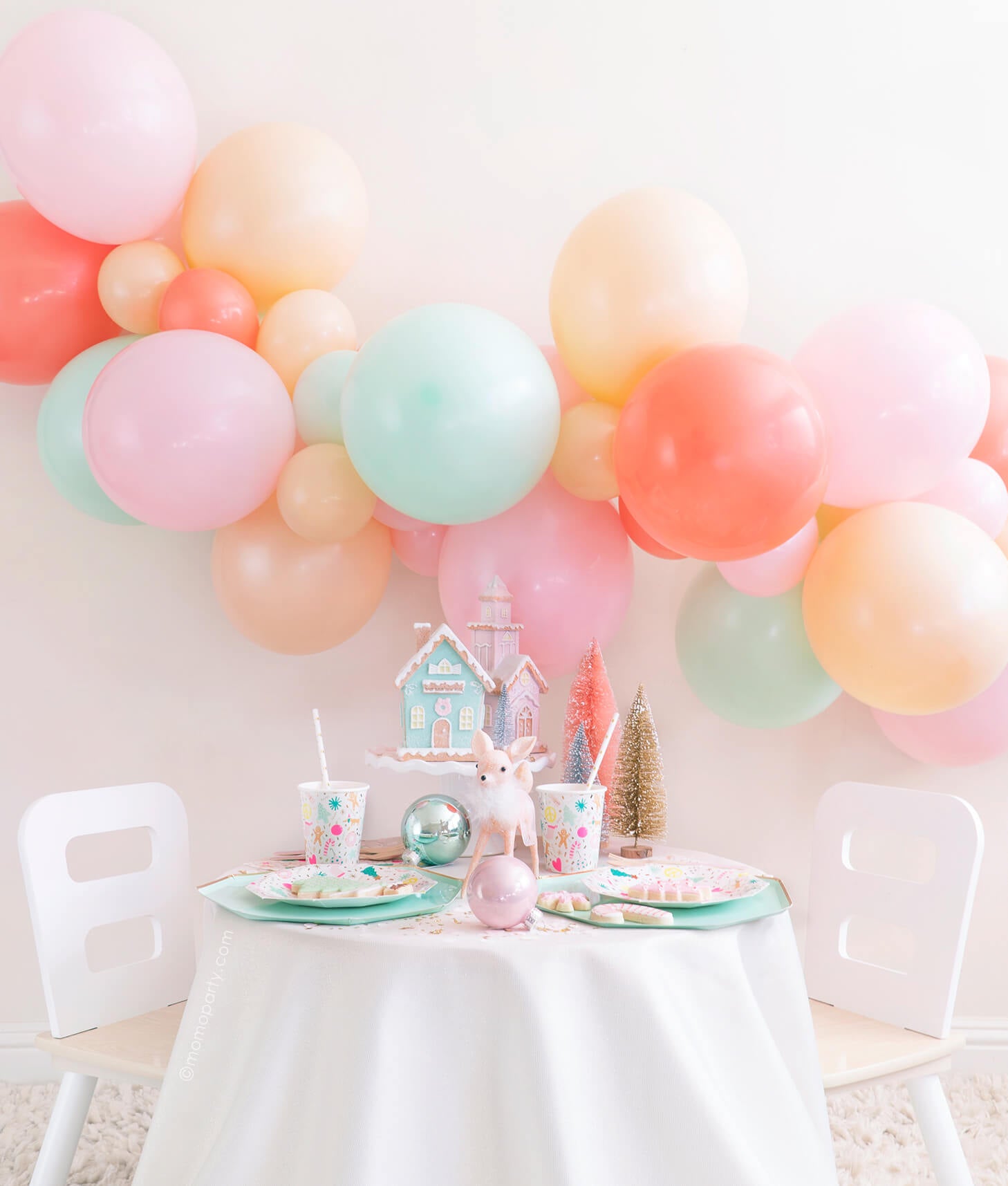 Momo Party Holiday party box - Merry & Bright Christmas Holiday Boxes. Feathering Pastel Color themed mint, peach, pink balloon garland as backdrop, Meri Meri Mint Large Dinner Plates, and Day dream societyMerry and Bright Small Plates, Napkins and Cups as tablewares for a modern cute pastel holiday party idea