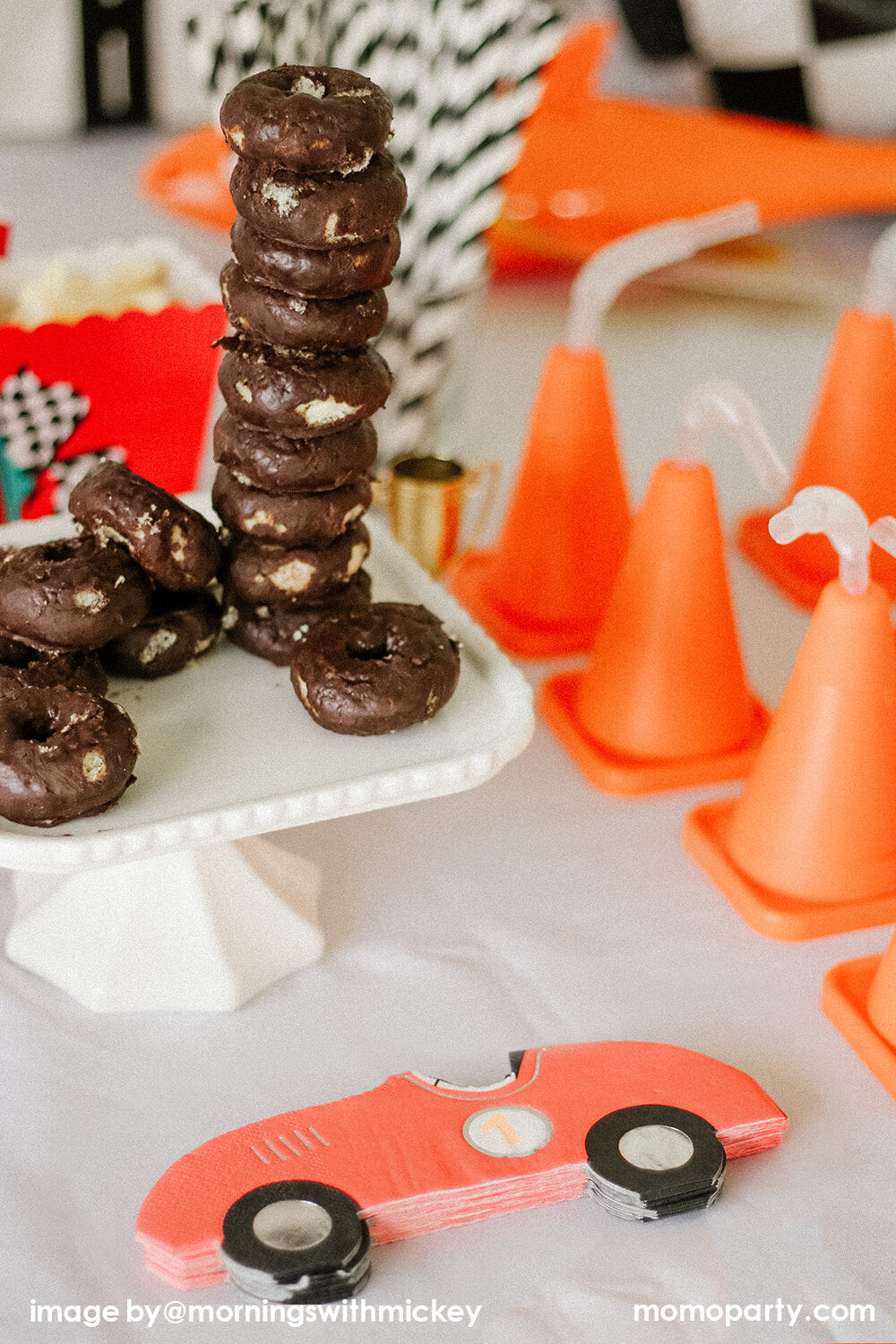 Disney Cars Themed Birthday Party Dessert table, decorated with chocolate mini donuts like car tires, Race Car Napkins, and construction cone cups. This modern Race Car Birthday party hosted by Momo Party with Mornings-with-Mickey is so fun for kids who love Disney Cars, Race Car and 2nd birthday
