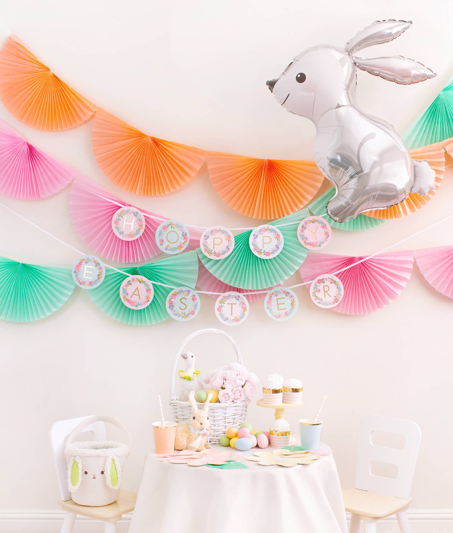 Momo Party Easter Party celebration box with Bunting Fan Garlands, Rifle Paper Garden Party Letter Garland, Woodland Bunny Foil Mylar Balloon as decoration, and Pastel Daisy Large Plates, Pastel Cups, Leaf Napkins and Easter Basket for dessert table