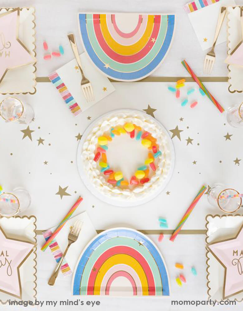 My Mind's Eye Unicorn plates with Magical star plates, a jelly bean cake on top of a Gold Stars Table Runner. This cute table set up make a Great magical rainbow party, twinkle twinkle little star themed party, a baby shower, or any everyday celebration!