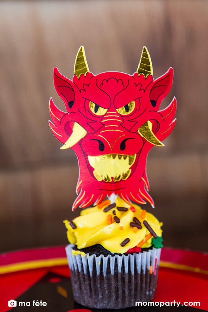 Momo Party's Ninja Cupcake Kit by Ma Fête. Featuring Dragon Head cupcake topper on the cupcake, The toppers include gold foil details to give cupcakes an eye-catching finish. They are perfect for a Ninja themed birthday party