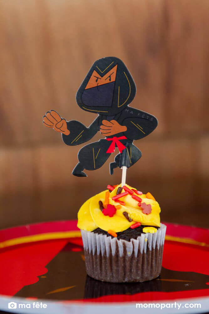 Momo Party's Ninja Cupcake Kit by Ma Fête. Featuring Ninja cupcake topper on the cupcake, The toppers include gold foil details to give cupcakes an eye-catching finish. They are perfect for a Ninja themed birthday party