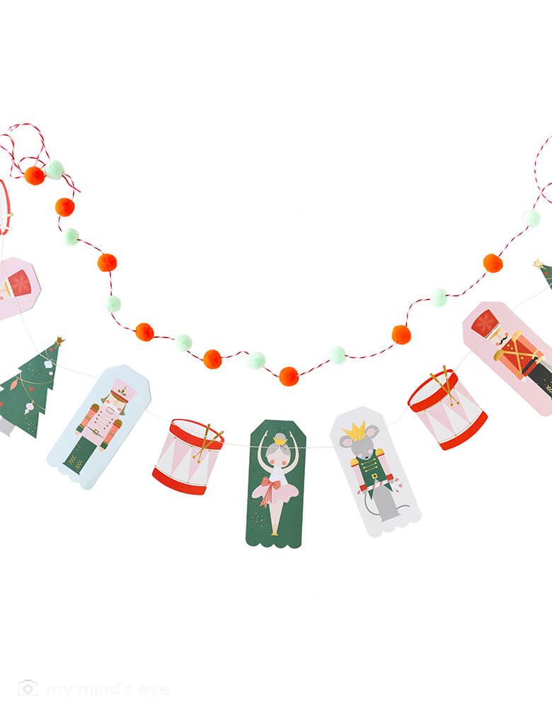 My Mind's Eye - Nutcracker Icon Banner. his whimsical banner set is inspired by the Nutcracker, and is sure to bring magic to your holiday this year! The icon banner features characters from this beloved classic with gold foil accents, and the pom pom banner adds dimension to your decor. Hang these banner to create a merry mantel or a festive Christmas treat table for your holiday season.